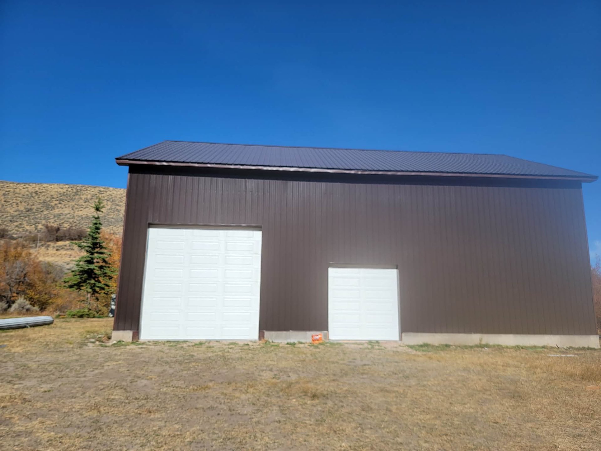 Featured project — bronze pole barn with matte black roof